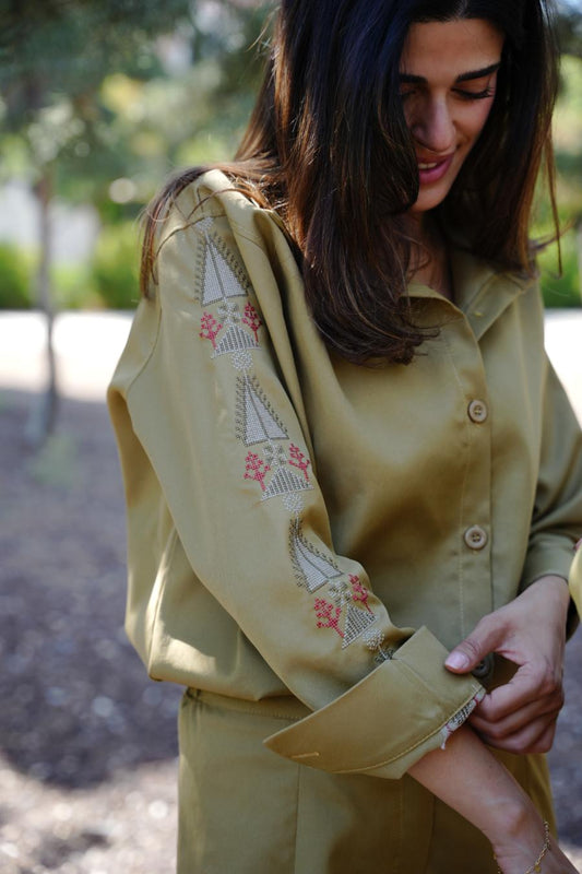 Woman wearing Olive mustard yellow coord set with tatreez embroidery  outdoors
